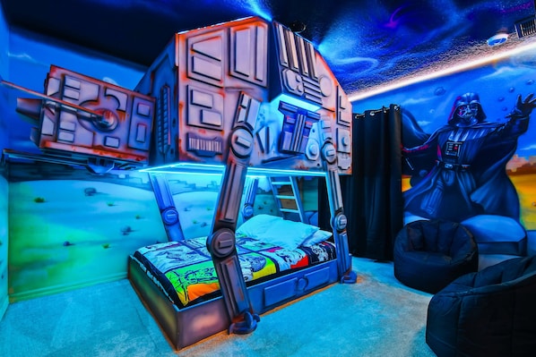 Epic Star Wars-themed bunk room with glowing lights and galactic wall art.