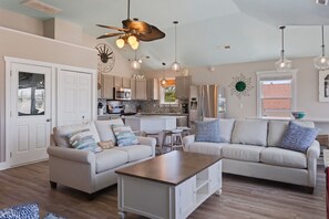 Unwind in the Living Area with plenty of cozy furniture and high ceilings.
