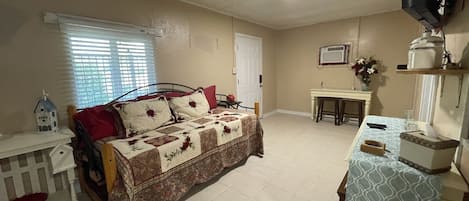 living room with roku tv and trundle bed with 2 twin beds