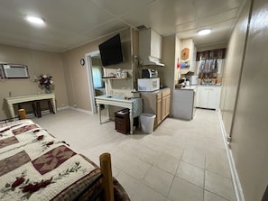 living room with roku tv and trundle bed with 2 twin beds. 