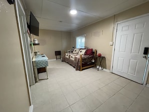 living room with roku tv and trundle bed with 2 twin beds