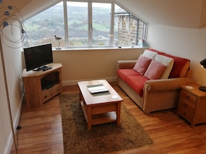 Open plan sitting area with smart T.V and DVD player.