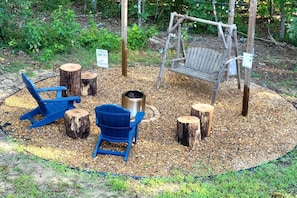 The outdoor sitting area is perfect for a cozy fire at night, making s'mores, or enjoying the swing on a nice day!