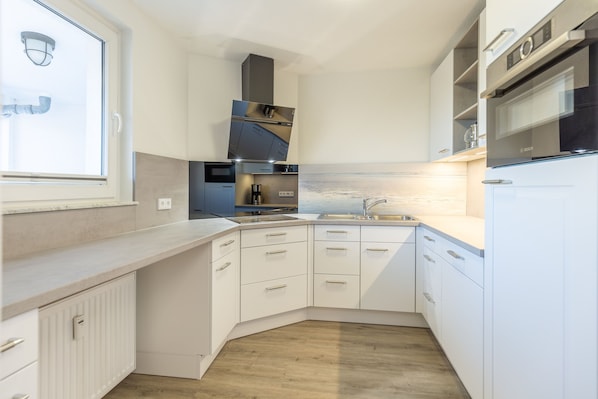 Separate Küche mit Backofen und Geschirrspüler.