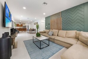 Living room: Large sofas, 65 “smart tv, coffee table, 