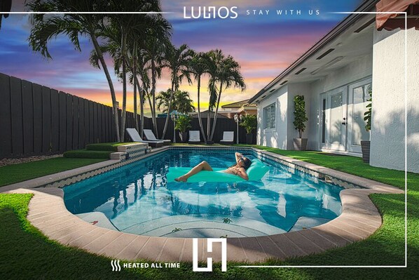 Summer poolside view with a woman enjoying the refreshing water under the sun
