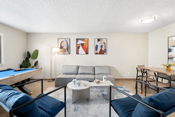 Spacious living room with pool table for entertainment