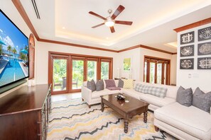Living area with sectional sofa and television. 