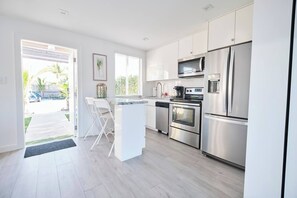 Chic & Organized Kitchenette | Seamless Cabinets, Orderly Drawers, Culinary Space Refined
