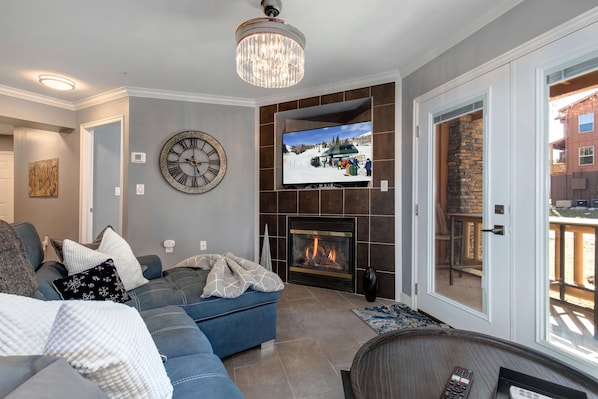 Fox Bay #H101_04: Cozy space with a fireplace and outdoor patio for relaxation.