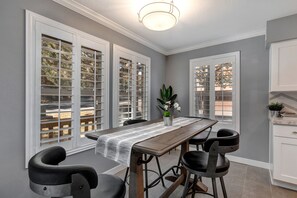 Dining table: "Sunlight streams through windows, illuminating the elegant dining table."