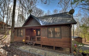 Front of cabin w/ stone walkway accented w/ solar lighting & motion lighting.