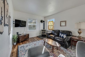 The stained-glass hanging from the window accentuates the classic décor creating a cozy place to gather