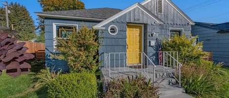 The bright yellow door & quaint patio greet you upon arrival