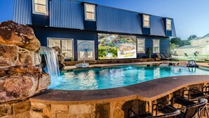 Our swimming pool with a grotto, perfect for a dive-in-movie in front of our 25' outdoor projector