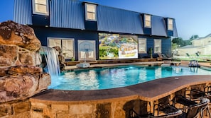 Our swimming pool with a grotto, perfect for a dive-in-movie in front of our 25' outdoor projector