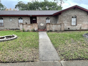 Front of house - closer view with front gate into porch and sitting area.
