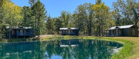 Three deluxe kozy kabins facing pond.