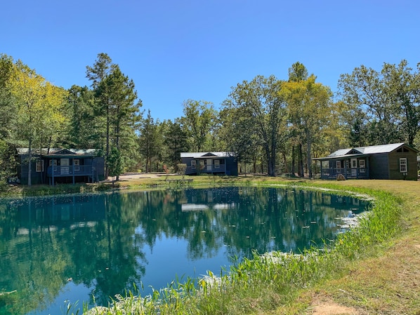 Three deluxe kozy kabins facing pond.