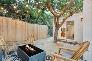 Relax and unwind around the fire pit and under the magical avocado tree!