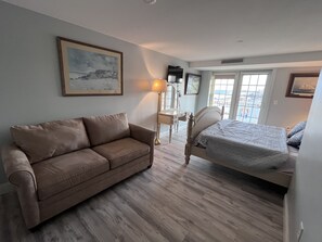 Master Bedroom with a king size solid wood bed and a full size pullout sofa bed 