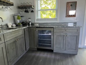 Wet bar with beverage fridge located near the backyard sliding door