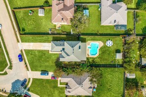 Aerial view of our home with massive backyard and expanded driveway!