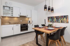 A well-equipped kitchen and dining area featuring wooden and metallic elements.