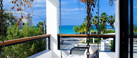 2nd floor balcony with swing and ocean view.