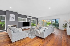 The main lounge room is beautifully decorated with coastal luxe furnishings