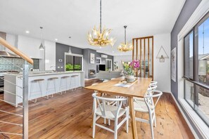 The dining room features chandeliers that evoke a Scandinavian feel