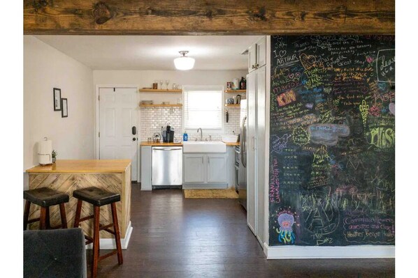 Living room into kitchen. Lots of art and positive reviews from our past guests.