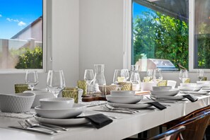 Ready for a feast! Our dining table can be set for 10, complete with full place settings. Enjoy a memorable meal with family and friends in style and comfort.