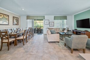 Spacious and inviting open-plan living and dining area, perfect for family gatherings with ample seating and natural light.