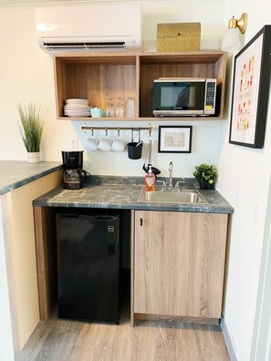 Wet bar, small refrigerator, microwave, sink, and most importantly a coffee maker.