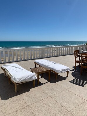 Beachfront Patios extend across entire property