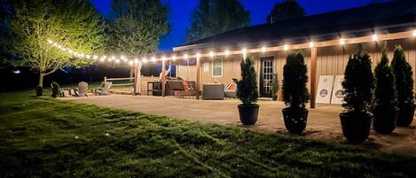 The outdoor living space at The Little Lodge is just as wonderful as inside. Space to spread out, a fire pit, covered hot tub, outdoor tv, corn hole, bocce ball, and even an outdoor ping pong table wait for you!