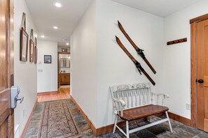 Through the entryway is a sitting area - down the hall is the full bath, a bedroom to the right, and the great room to the left