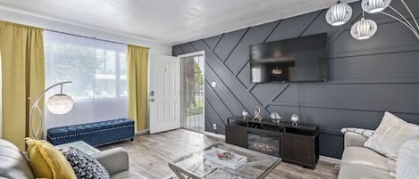 Living Room Area with Electrical Fireplace and 'blue tooth' Jukebox Speaker