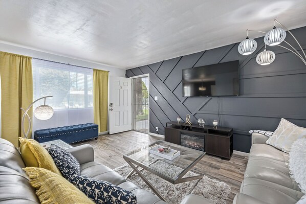 Living Room Area with Electrical Fireplace and 'blue tooth' Jukebox Speaker