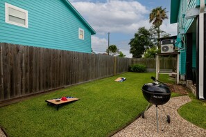 Spacious backyard with grill and cornhole set!
