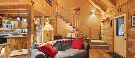 Step into rustic elegance in our living room, where exposed beams and cozy furnishings create a warm and inviting space for relaxation and connection.