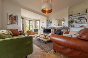 Linksway House, Old Hunstanton: Sitting room with comfortable sofas and wood burning stove