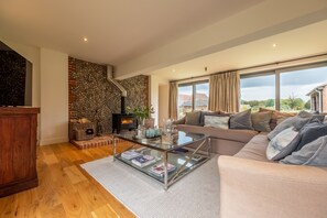 The Hayloft, Felbrigg: Sitting room with wood burning stove