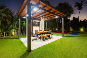 Outdoor dining table + TV.