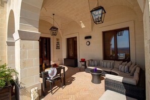 Outdoor dining are with vaulted ceilings and pool views.