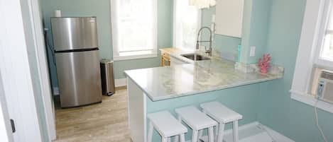 Fully stocked kitchen with quartzite countertops!