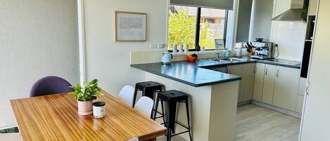 Open plan dining and kitchen. The dining table extends to seat up to 10