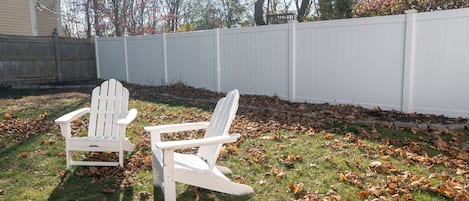 Relax on the Adirondack chairs in this spacious fenced in backyard