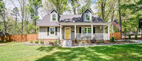 Rocking chair front porch shaded by beautiful 100+ year old oak trees